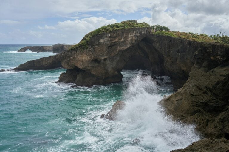 A large body of water next to a rocky cliff