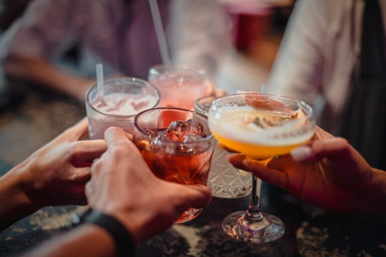 A group of people holding drinks in their hands