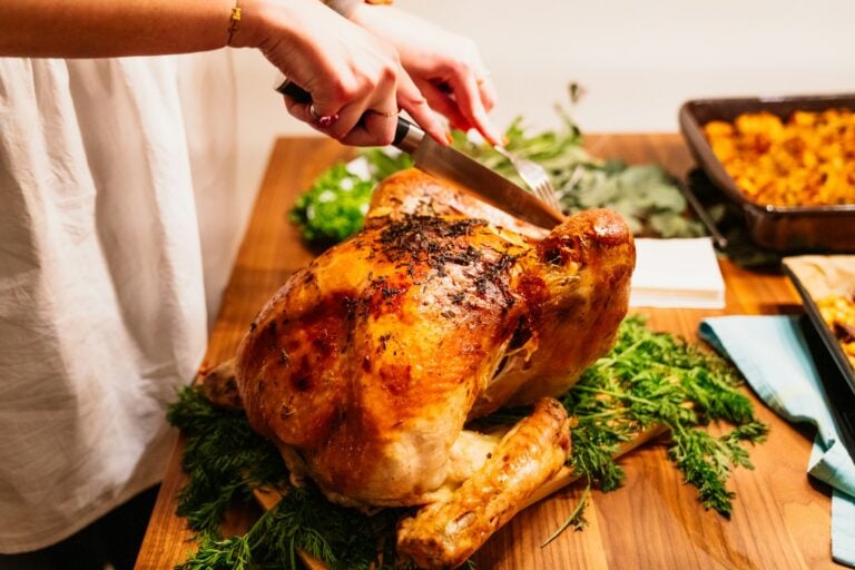 person about to slice the roasted chicken