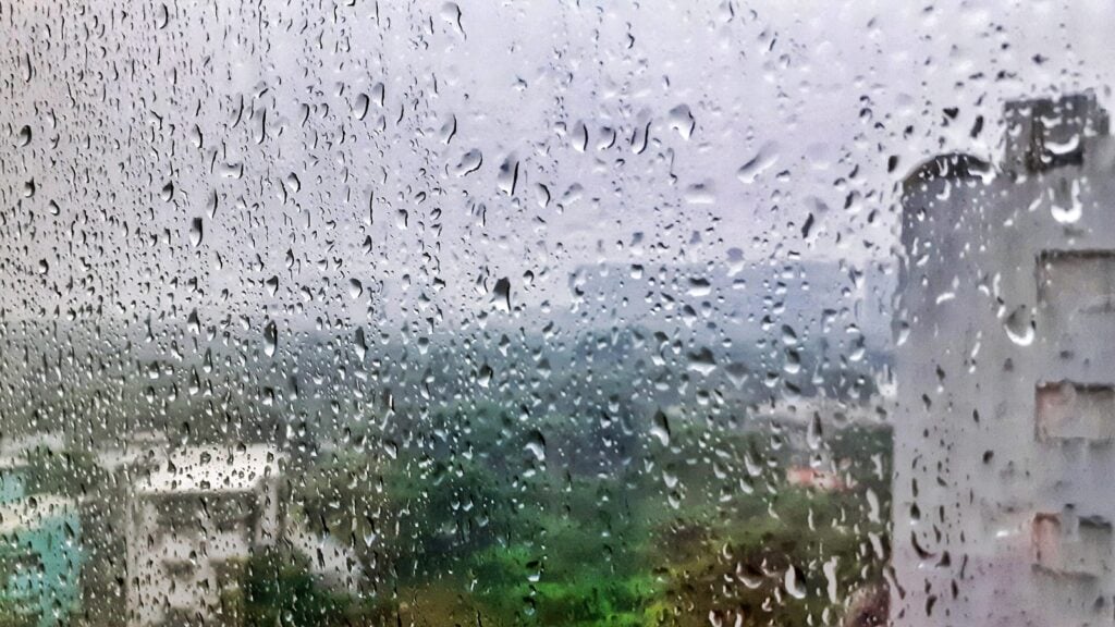Raindrops on a window overlooking a city