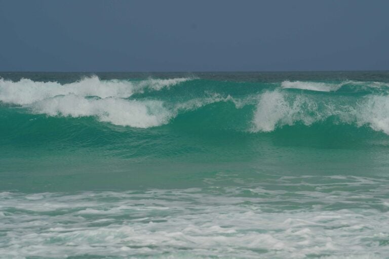 Breaking ocean waves roll towards the shore.