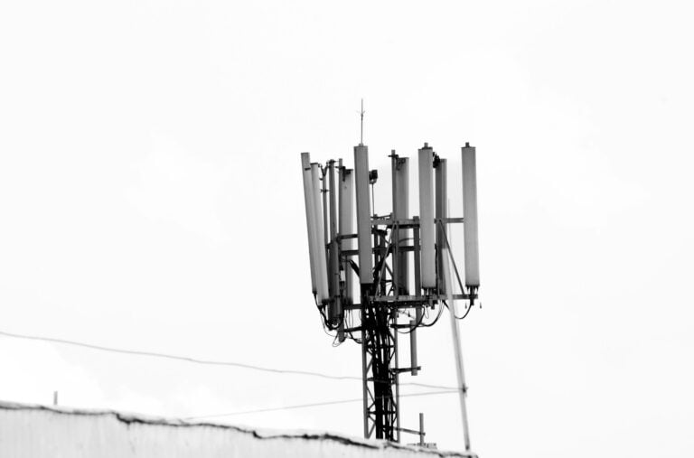 a black and white photo of a cell phone tower