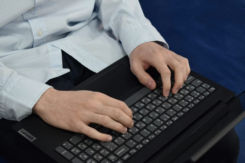 Person typing on a laptop keyboard