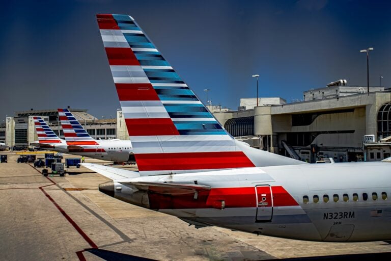 a row of american airlines planes parked at an airport